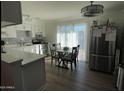 Bright kitchen with white cabinets, stainless steel appliances, and an island at 524 W Fairway Dr # 12, Mesa, AZ 85201