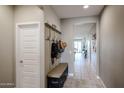 Bright entryway with bench, cubbies and open view to the kitchen at 5523 W Chuck Box Rd, Laveen, AZ 85339