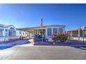 Mobile home with covered porch and American flag at 7750 E Broadway Rd # 156, Mesa, AZ 85208