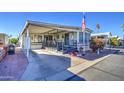 Mobile home with covered porch and spacious yard at 7750 E Broadway Rd # 156, Mesa, AZ 85208