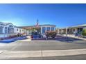 Mobile home with covered porch and American flag at 7750 E Broadway Rd # 156, Mesa, AZ 85208