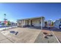 Mobile home with covered patio and parking at 7750 E Broadway Rd # 495, Mesa, AZ 85208