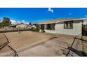 Property's exterior, showing ample yard space and driveway at 927 S Grand --, Mesa, AZ 85210