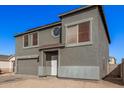 Two-story house with gray siding, attached garage, and landscaping at 11514 W Charter Oak Rd, El Mirage, AZ 85335