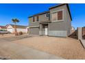 Two-story house with gray siding, attached garage, and landscaping at 11514 W Charter Oak Rd, El Mirage, AZ 85335