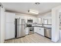 Modern kitchen featuring stainless steel appliances and white shaker cabinets at 11782 W Columbine Dr, El Mirage, AZ 85335