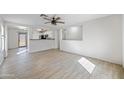 Bright and airy living room with wood-look tile flooring and ceiling fan at 11782 W Columbine Dr, El Mirage, AZ 85335