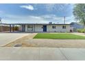 Modern single story home with a white exterior and green lawn at 1209 E Marigold Ln, Tempe, AZ 85288