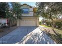 Two-story house with attached garage and driveway at 13441 W Rose Ln, Litchfield Park, AZ 85340