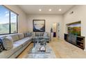 Spacious living room showcasing a large sectional sofa and a built-in entertainment center at 13462 E Wethersfield Rd, Scottsdale, AZ 85259