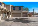 Two-story house with tan exterior, and a two-car garage at 16118 W Gibson Ln, Goodyear, AZ 85338