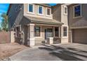 Two-story house with tan exterior, and a two-car garage at 16118 W Gibson Ln, Goodyear, AZ 85338