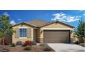 New construction home with a brown garage door and landscaping at 17215 W Corrine Dr, Surprise, AZ 85388