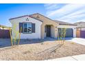 Inviting single-story home featuring desert landscaping, an attached two-car garage, and covered entrance at 17469 N 66Th Ave, Glendale, AZ 85308