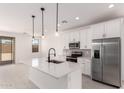 Bright kitchen showcasing stainless steel appliances, island, and modern white cabinetry at 18556 E Dario Rd, Gold Canyon, AZ 85118