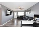 Comfortable living room with gray walls, luxury vinyl flooring, a ceiling fan, and television at 1905 W 2Nd St, Mesa, AZ 85201