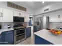 Stylish kitchen with stainless steel appliances, modern cabinets, and a view into dining area at 19531 N 69Th Ave, Glendale, AZ 85308