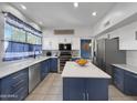 Well-appointed kitchen featuring white cabinets, stainless steel appliances, and a center island at 19531 N 69Th Ave, Glendale, AZ 85308