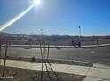 View of a residential street with new construction homes and desert landscape at 20863 N 223Rd Ave, Surprise, AZ 85387