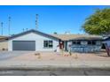 Updated mid-century modern home with gray exterior and red door at 2112 E Fremont Dr, Tempe, AZ 85282