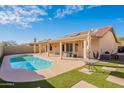 Inviting backyard pool, patio, and artificial turf create an outdoor oasis for relaxation and recreation at 2217 E Devon Ct, Gilbert, AZ 85296