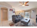 Living room with gray sectional sofa, sliding glass door to pool, and dining area at 2217 E Devon Ct, Gilbert, AZ 85296