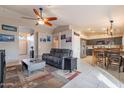 Open living room and kitchen with gray sectional sofa and dining area at 2217 E Devon Ct, Gilbert, AZ 85296