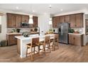 Modern kitchen with dark wood cabinets and white countertops at 22645 W Irma Ln, Surprise, AZ 85387