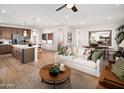 Open living area with kitchen island and modern furniture at 22645 W Irma Ln, Surprise, AZ 85387