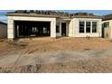 New construction home with unfinished landscaping and exposed framing at 22708 E Lords Way, Queen Creek, AZ 85142