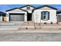 Charming single-story home featuring a gray garage door, white exterior paint, and a desert-landscaped yard at 22740 E Lords Way, Queen Creek, AZ 85142