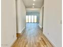 Hallway featuring recessed lighting and wood-look floors leading to the sliding doors that lead to backyard at 22740 E Lords Way, Queen Creek, AZ 85142