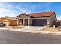 One-story house with brown roof and gray exterior, two-car garage, and desert landscaping at 2355 N Oakmont Ln, Casa Grande, AZ 85122