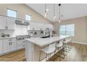 Modern kitchen with white cabinets, large island, and stainless steel appliances at 25802 N Hackberry Dr, Phoenix, AZ 85083