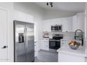 Modern kitchen with white cabinets, stainless steel appliances, and quartz countertops at 3930 W Saragosa W St, Chandler, AZ 85226