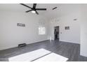 Spacious living room featuring gray vinyl flooring and a ceiling fan at 3930 W Saragosa W St, Chandler, AZ 85226