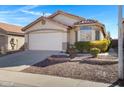 House exterior with a two-car garage and desert landscaping at 415 E Glenhaven Dr, Phoenix, AZ 85048