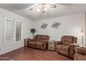 Living room with two brown leather recliners and wood flooring at 4301 W Dahlia Dr, Glendale, AZ 85304