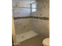 Large walk in shower with marble tile at 469 W Newmont St, Superior, AZ 85173