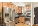 Modern kitchen featuring stainless steel appliances and wood cabinets at 4800 N 68Th St # 264, Scottsdale, AZ 85251