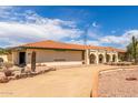 Ranch style home with arched entryway and gravel driveway at 4832 W Saguaro Park Ln, Glendale, AZ 85310