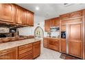 Spacious kitchen with wood cabinets and granite countertops at 4832 W Saguaro Park Ln, Glendale, AZ 85310