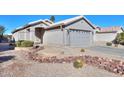 House exterior with a landscaped front yard and gravel driveway at 498 N Santiago Trl, Casa Grande, AZ 85194