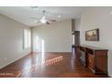 Spacious living room featuring hardwood floors and a fireplace at 498 N Santiago Trl, Casa Grande, AZ 85194