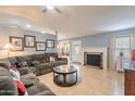 Living room with a fireplace, sectional sofa, and tile floors at 6340 W Ironwood Dr, Glendale, AZ 85302