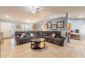 Spacious living room featuring a comfortable sectional sofa and tile floors at 6340 W Ironwood Dr, Glendale, AZ 85302