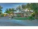 Stunning home with a lush lawn and inviting front entrance at 6502 N 81St Pl, Scottsdale, AZ 85250