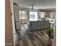 Spacious living room with light grey couch and wood-look flooring at 805 W Raymond St, Coolidge, AZ 85128