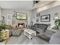 Bright living room featuring a fireplace and ample seating at 8149 W Daley Ln, Peoria, AZ 85383