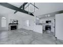 Open concept living room with kitchen, fireplace, and high ceilings at 10115 E Mountain View Rd # 2022, Scottsdale, AZ 85258